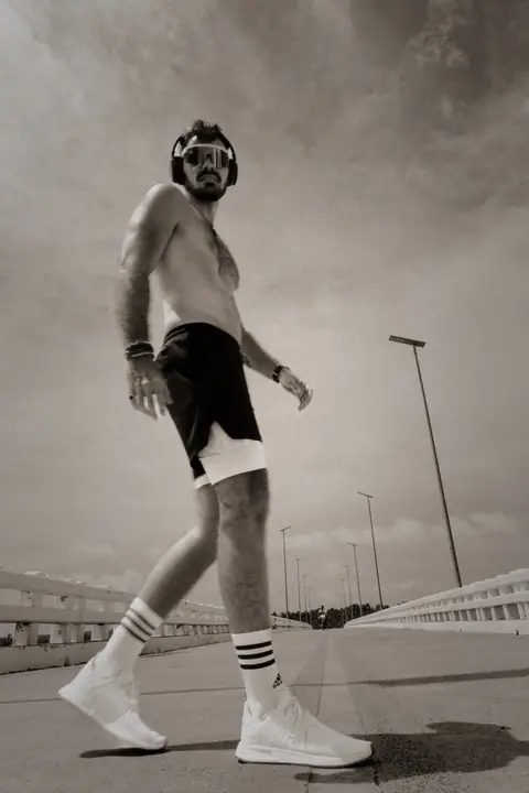 Personal branding voor Run Freak, Lukas loopt stoer over de brug in kikvorsperspectief